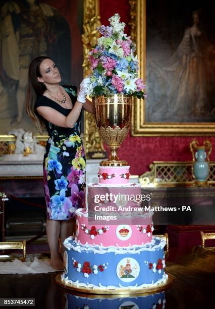 Curator Anna Reynolds adds the finishing touches to a replica of the Christening Cake of Prince Leopold, Queen Victoria's youngest son, during a...