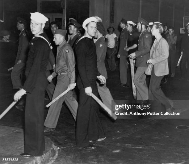Gangs of American sailors and marines armed with sticks during the Zoot Suit Riots, Los Angeles, California, June 1943. The riots broke out as...