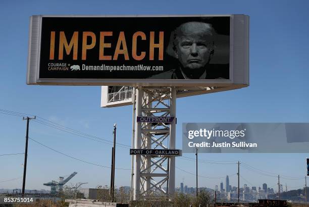 An electronic billboard next to the San Francisco-Oakland Bay Bridge reads "IMPEACH" with an image of U.S. President Donald Trump on September 25,...