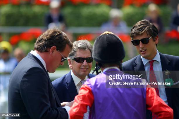 John Warren , the Queen's bloodstock and racing adviser talks to jockey Richard Hughes before the first race during the King George Day - Saturday at...