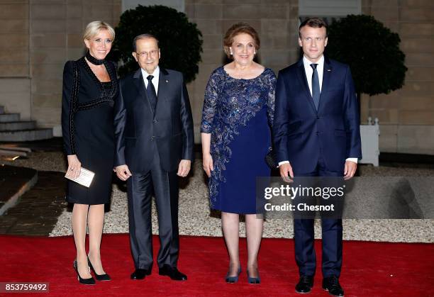 French President Emmanuel Macron and his wife Brigitte Macron pose with Lebanese President Michel Aoun and his wife Nadia Aoun prior to a state...