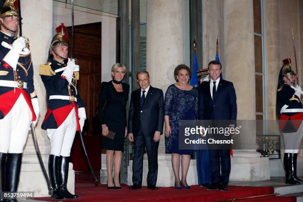 French President Emmanuel Macron and his wife Brigitte Macron pose with Lebanese President Michel Aoun and his wife Nadia Aoun prior to a state...