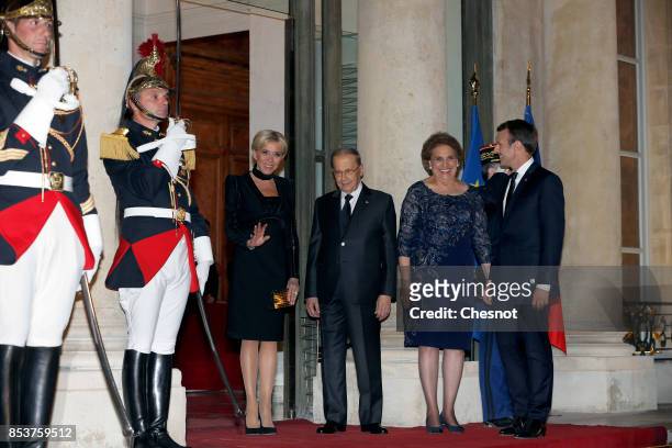 French President Emmanuel Macron and his wife Brigitte Macron pose with Lebanese President Michel Aoun and his wife Nadia Aoun prior to a state...