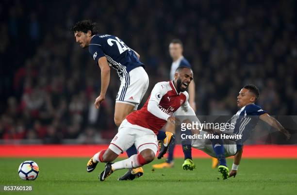 Alexandre Lacazette of Arsenal is challenged by Ahmed El-Sayed Hegazi and Kieran Gibbs of West Bromwich Albion during the Premier League match...