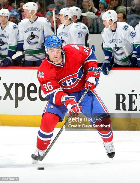 Matt D'Agostini of the Montreal Canadiens skates the Vancouver Canucks during the NHL game at the Bell Centre on February 24, 2009 in Montreal,...