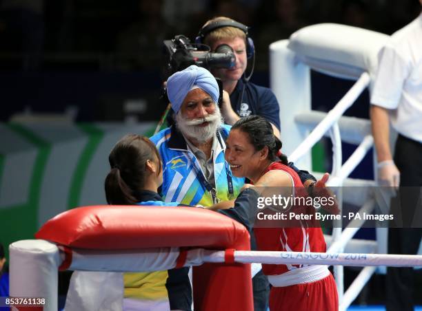 India's Laishram Devi celebrates her win against Mozambique's Maria Machongua in the Women's Light Semi-final 2 at the SECC, during the 2014...