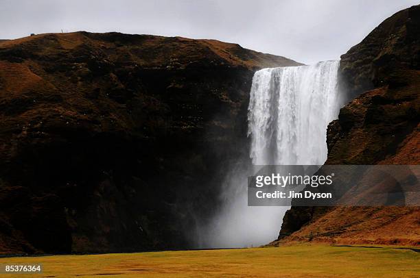 The 60 metre high Skogafoss waterfall cascades down a mountain on February 20, 2009 in the south of Iceland. A country of glacial and volcanic...