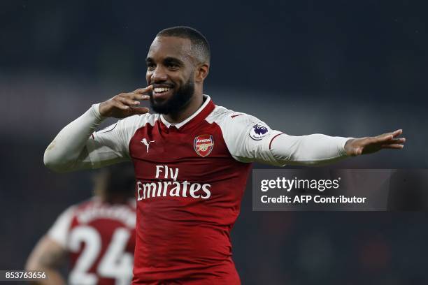 Arsenal's French striker Alexandre Lacazette celebrates scoring his team's second goal from the penalty spot during the English Premier League...