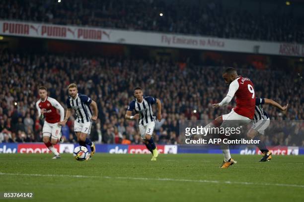 Arsenal's French striker Alexandre Lacazette shoots from the penalty spot to score his team's second goal during the English Premier League football...