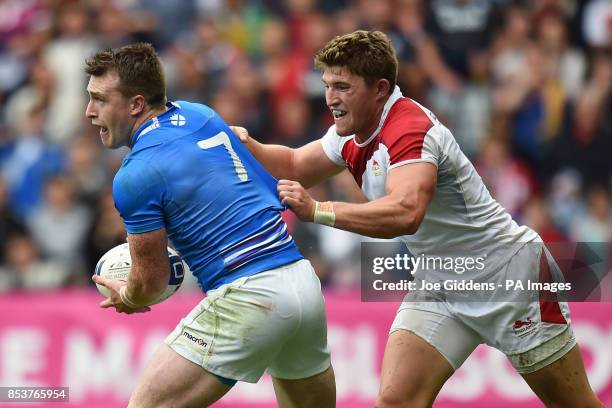 Scotland's Stuart Hogg is tackled by England's Philip Burgess during the rugby Sevens at Ibrox Stadium, during the 2014 Commonwealth Games in Glasgow.