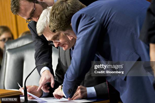 Senator Bill Cassidy, a Republican from Louisiana, center, talks to aides during a disruption in a Senate Finance Committee hearing to consider the...