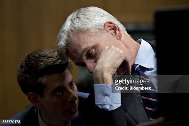 Senator Bill Cassidy, a Republican from Louisiana, speaks to an aide during a Senate Finance Committee hearing to consider the...