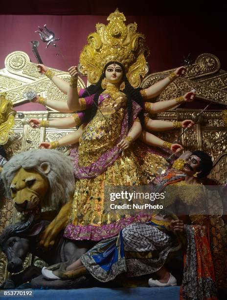 An Idol goddess of Durga with a saree made of 22 kgs of gold beautified with zari work embossed on it at Santosh Mitra Square Puja pandal in Kolkata...