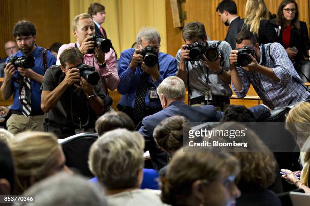Photographers surround Senator Lindsey Graham, a Republican from South Carolina, center, during a disruption in a Senate Finance Committee hearing to...