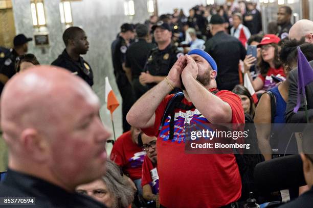 Member of the disability rights group ADAPT shouts slogans in the hallway outside a Senate Finance Committee hearing to consider the...