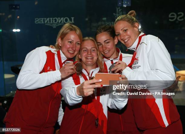 England's Jenny Duncalf and Laura Massaro with Emma Beddoes and Alison Waters celebrate their medals won in the Women's Doubles Squash at Scotstoun...