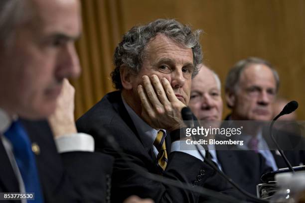 Senator Sherrod Brown, a Democrat from Ohio, center, listens during a Senate Finance Committee hearing to consider the Graham-Cassidy-Heller-Johnson...