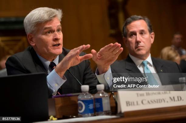 Senator Bill Cassidy, Republican of Louisiana, testifies alongside former US Senator Rick Santorum during a US Senate Committee on Finance hearing on...