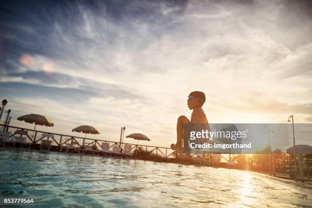 little boy jumping into swimming pool - kid jumping into swimming pool stock pictures, royalty-free photos & images