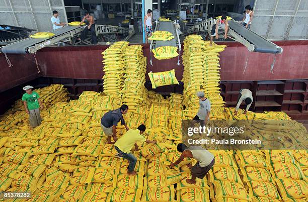Workers load a ship with 1000 tons of rice bound for Africa at the Asia Golden Rice export company on March 11, 2009 in Bang Pakong, Thailand. The...