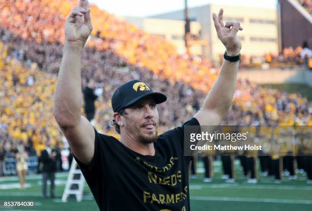 Former linebacker Chad Greenway of the Iowa Hawkeyes and Minnesota Vikings waves to the fans during the honorary captain announcement before the...