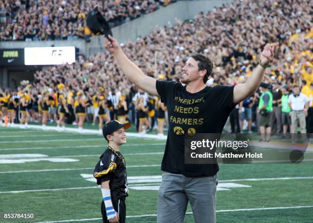 Former linebacker Chad Greenway of the Iowa Hawkeyes and Minnesota Vikings waves to the fans during the honorary captain announcement before the...