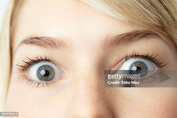 eyes of young woman, close-up - gray eyes stock-fotos und bilder