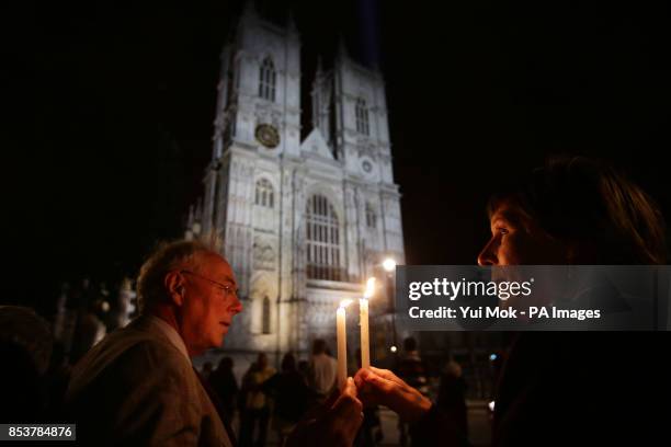 Paul and Alison Schulte holding candles outside Westminster Abbey, in London, during a candle lit prayer vigil and solemn reflection to mark...