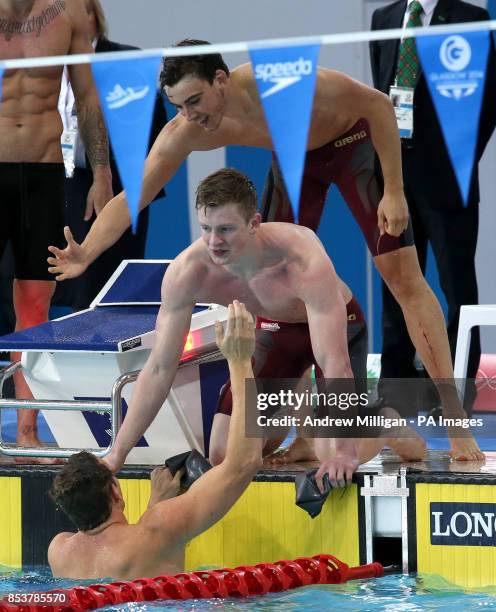 England's Adam Brown celebrates winning the gold medal after the Men's 4 x 100m Medley Relay Final with teammates Adam Barrett and Adam Peaty, at...