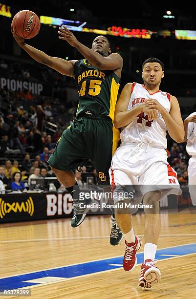 Guard Tweety Carter of the Baylor Bears takes a shot against Ryan Anderson of the Nebraska Cornhuskers during the Phillips 66 Big 12 Men's Basketball...