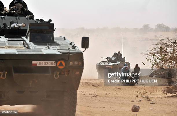 Polish Soldiers, part of the European Force , patrol a village near Iriba, in eastern Chad on March 11, 2009 four days before the end of the European...