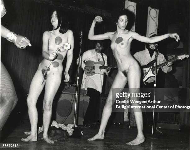 Naked young women, with dots painted on them, dance in front of a rock band, during a performance, a Body Festival, organized by artist Yayoi Kusama...