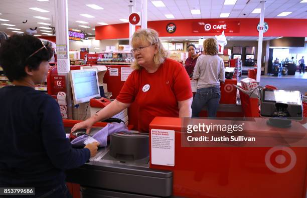 Target worker Ellen Gibran-Hesse helps a customer at a Target store on September 25, 2017 in San Rafael, California. Target Corp. Annouced plans to...