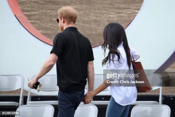 Prince Harry and Meghan Markle depart from a Wheelchair Tennis match during the Invictus Games 2017 at Nathan Philips Square on September 25, 2017 in...