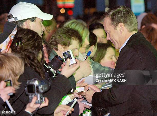 Actor Kiefer Sutherland signs autographs for fans as he arrives for the British Premiere of his latest film, Monsters versus Aliens, in London's...