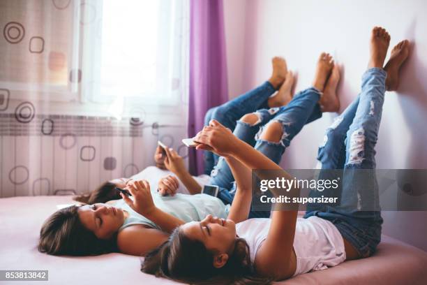 teens using social media - ripped jeans stock pictures, royalty-free photos & images