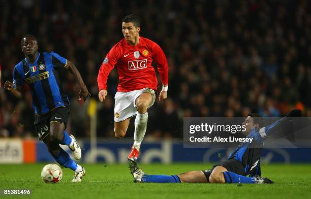 Cristiano Ronaldo of Manchester United goes past the challenge of Javier Zanetti of Inter Milan during the UEFA Champions League Round of Sixteen,...