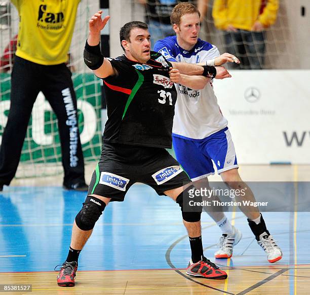 Stefan Kneer of Grosswallstadt in action with Bartosz Jurecki of Magdeburg during the Toyota Handball Bundesliga match between TV Grosswallstadt and...