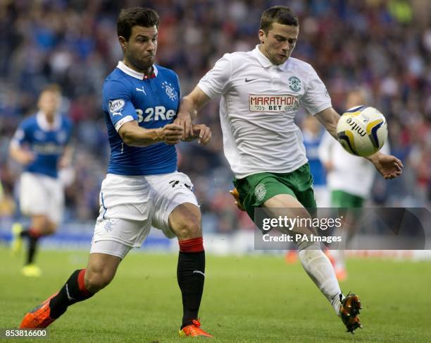Rangers' Richard Foster and Hibernian's Lewis Stevenson battle for the ball during the Petrofac Training Cup match at Ibrox, Glasgow.