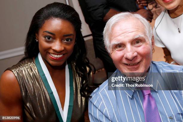 Honoree Simone Biles and GSLD Host Nick Buoniconti attends the 32nd Annual Great Sports Legends Dinner To Benefit The Miami Project/Buoniconti Fund...