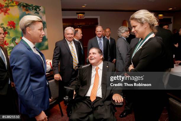 Honoree Abby Wambach, GSLD Host Marc Buoniconti and GSLD Honoree Kim Clijsters attend the 32nd Annual Great Sports Legends Dinner To Benefit The...