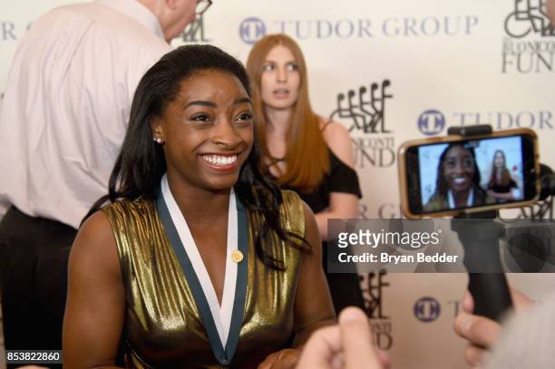 Simone Biles attends the 32nd Annual Great Sports Legends Dinner To Benefit The Miami Project/Buoniconti Fund To Cure Paralysis Legends Reception at...