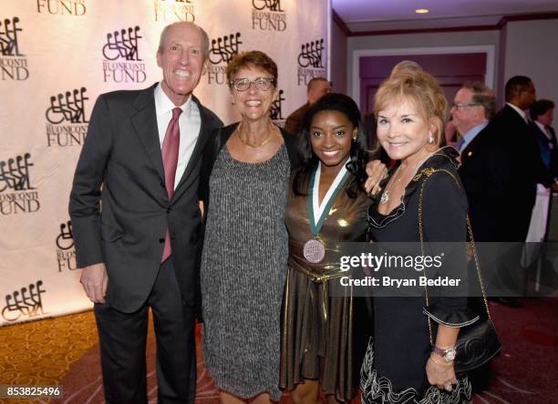 Dr. Edward Abraham, 4-time Olympic Gold Medal Gymnast Simone Byles, and Swanee DiMare attend the 32nd Annual Great Sports Legends Dinner To Benefit...