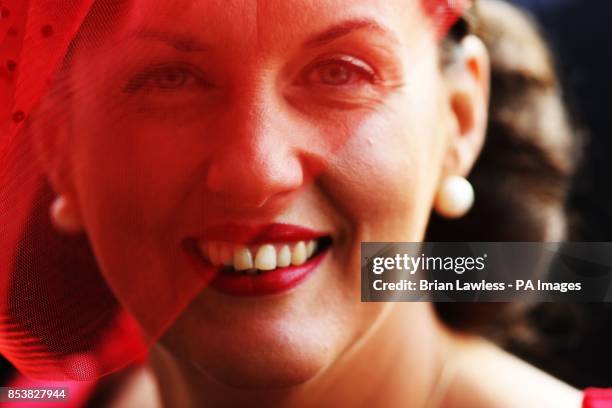 Bernie McGarrity, from Malahide, awaits the results of the best dressed lady competition at Leopardstown Racecourse, Dublin, Ireland.