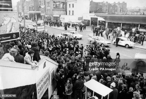 The Salvation Army plays to the crowd waiting for the Rolling Stones' farewell concert at the Roundhouse in Chalk Farm.