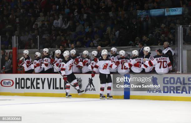 Members of the New Jersey Devils celebrate their second goal against the Ottawa Senators during Kraft Hockeyville Canada on September 25, 2017 at...