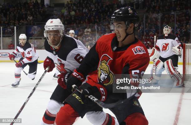 Andy Greene of the New Jersey Devils checks Alex Formenton of the Ottawa Senators during Kraft Hockeyville Canada on September 25, 2017 at Credit...