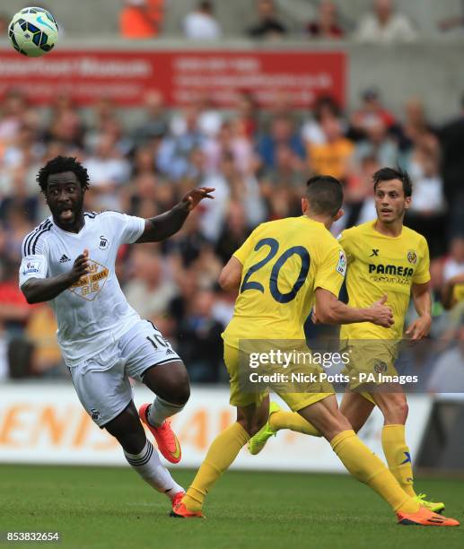 Swansea City's Wilfried Bony holds off Villarreal's Gabriel Paulista , during the pre-season friendly at the Liberty Stadium, Swansea.