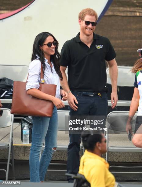 Meghan Markle and Prince Harry hold hands the Wheelchair Tennis on day 3 of the Invictus Games Toronto 2017 at Nathan Philips Square on September 25,...