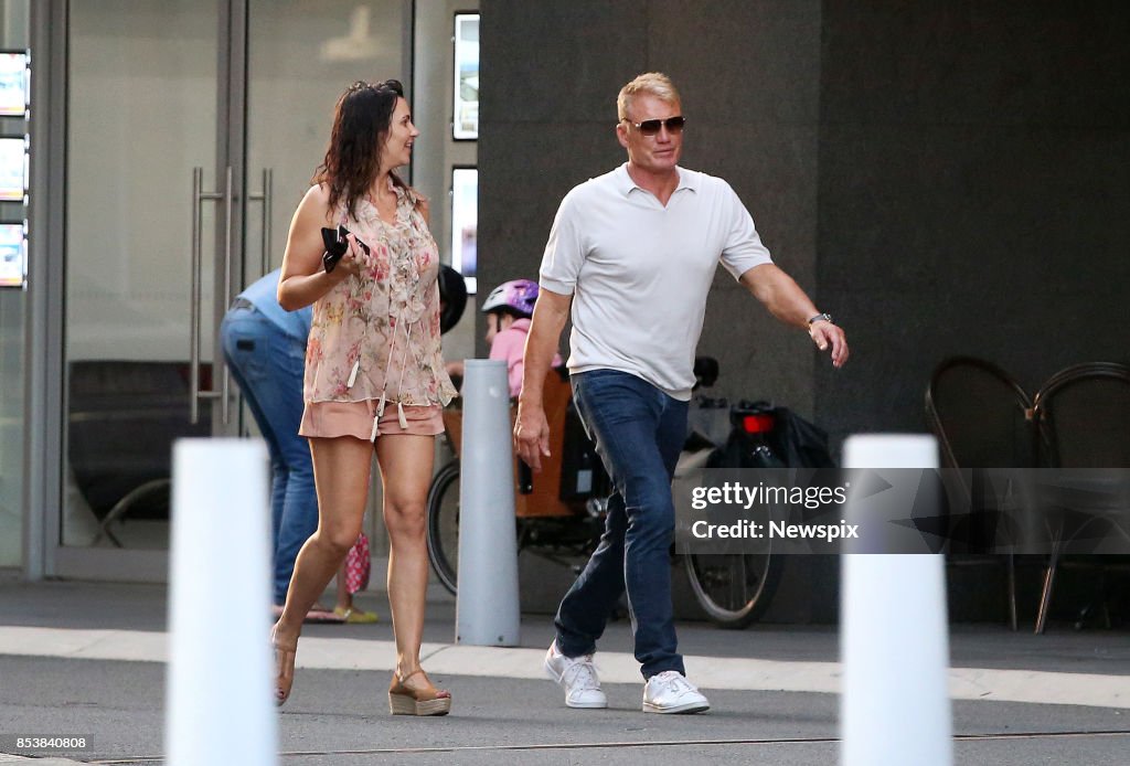 Actor Dolph Lundgren and Jenny Sandersson walk around Broadbeach on